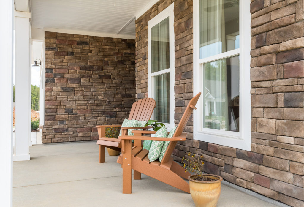 model home front porch outdoor living stone 55+ living