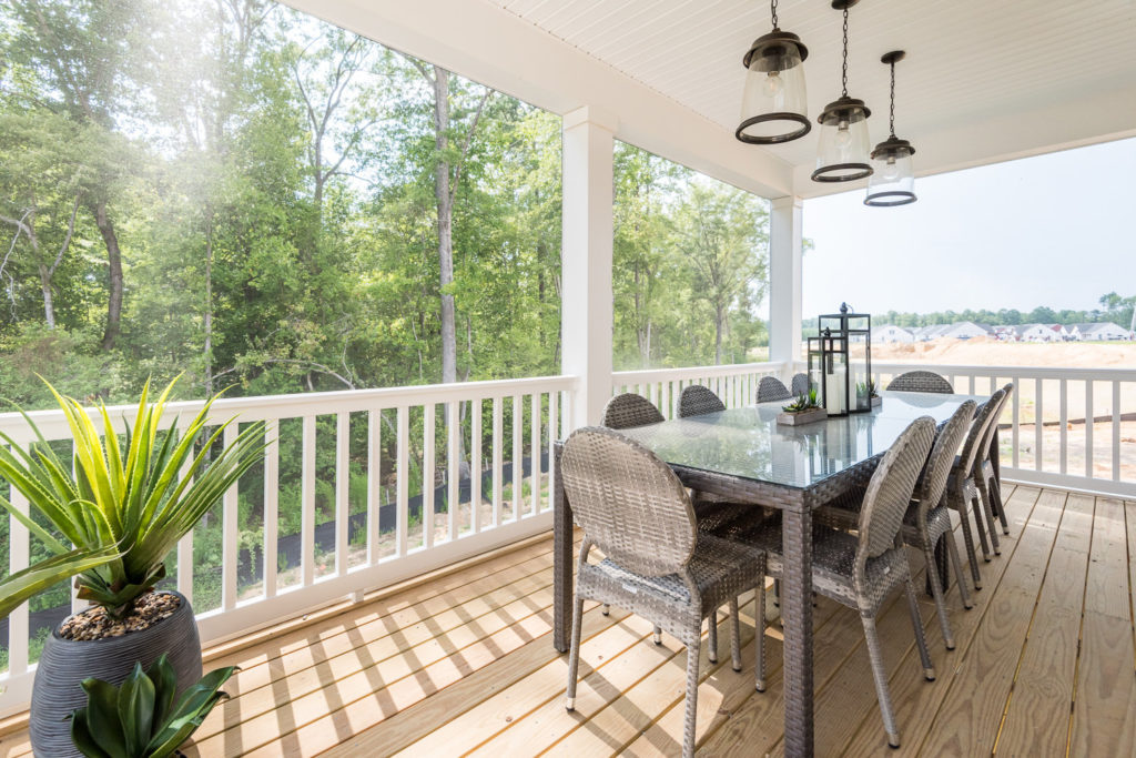 model home screened in porch outdoor living dining table